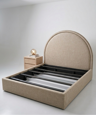 Beige upholstered bed frame with a round headboard on a white background