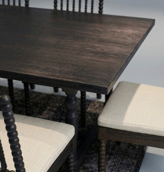 Wooden dining table with chairs in a room setting