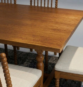 Wooden dining table with chairs in a room setting