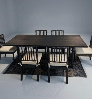 Dining table set with chairs and cushions on a gray background