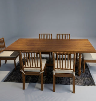 Wooden dining table with chairs on a gray background