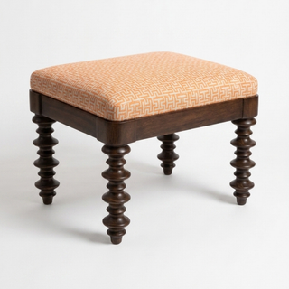 Wooden stool with patterned cushion on a white background